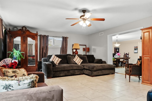 living room featuring ceiling fan and light tile patterned floors