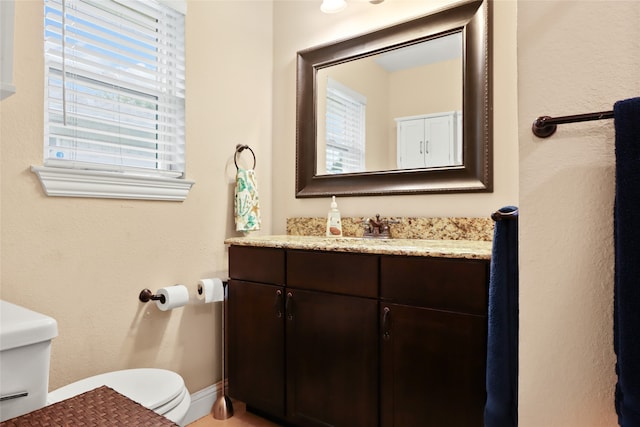 bathroom featuring toilet and vanity