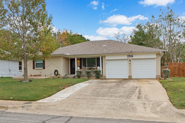 ranch-style house featuring a front lawn and a garage