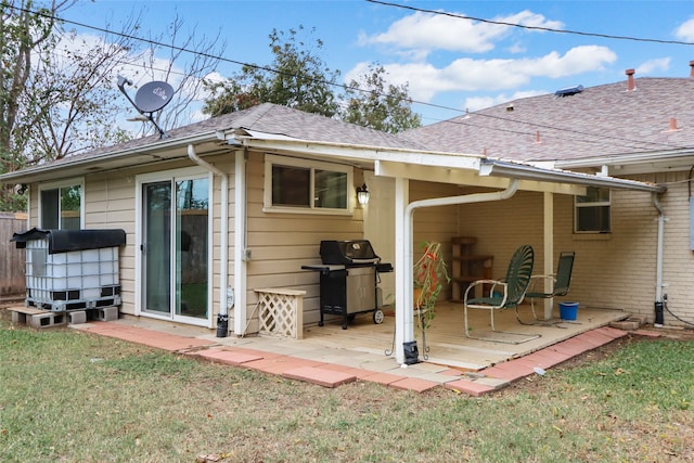 back of property with a patio area and a lawn