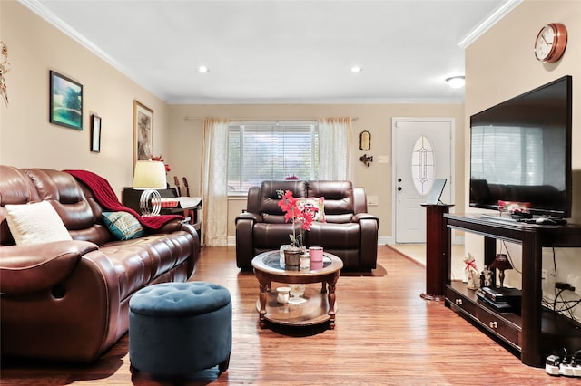 living room with light hardwood / wood-style flooring and ornamental molding