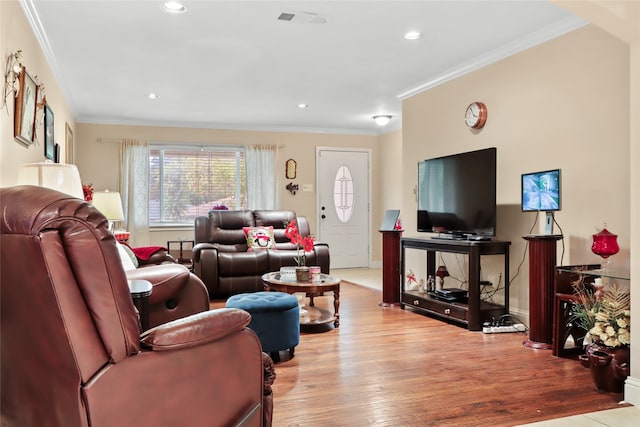 living room featuring light hardwood / wood-style floors and crown molding