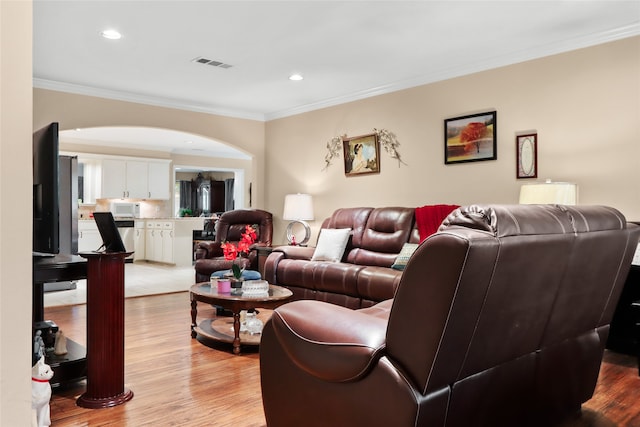 living room featuring light hardwood / wood-style flooring and ornamental molding