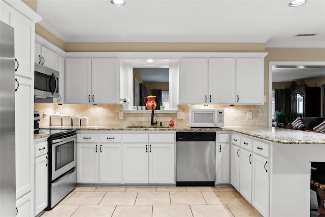 kitchen featuring white cabinets, kitchen peninsula, and stainless steel appliances