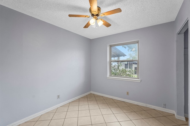 tiled empty room with a textured ceiling and ceiling fan