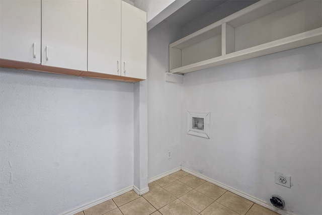 washroom with cabinets, hookup for a washing machine, light tile patterned floors, and electric dryer hookup