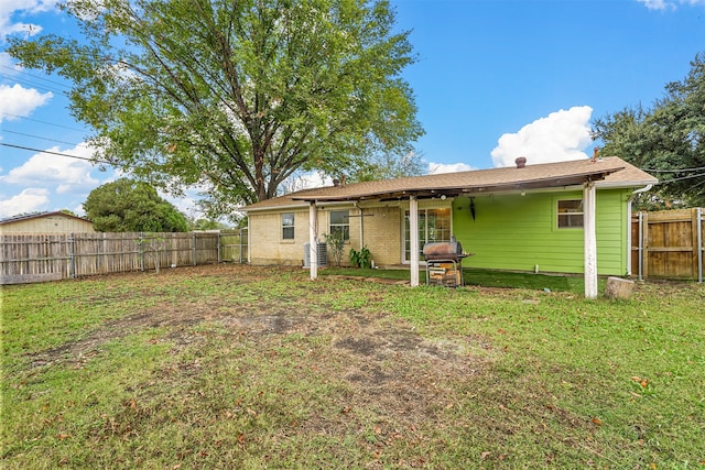 back of house with ceiling fan, a yard, and a patio area