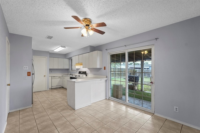 kitchen with stainless steel stove, a textured ceiling, white dishwasher, white cabinets, and ceiling fan