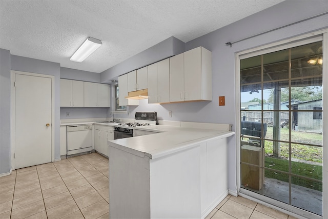 kitchen with a textured ceiling, black gas stove, white dishwasher, sink, and white cabinets