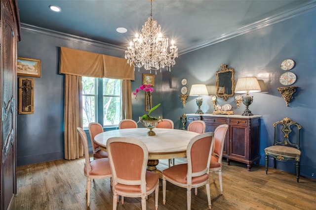 dining room featuring hardwood / wood-style floors, a chandelier, and ornamental molding