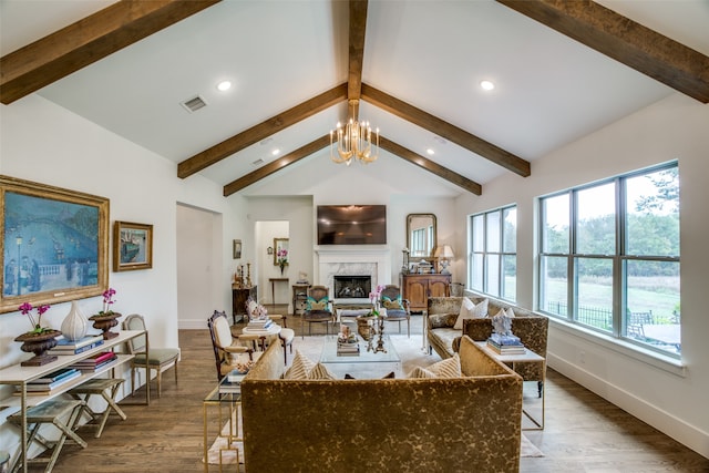 living room with dark hardwood / wood-style flooring, a chandelier, vaulted ceiling with beams, and a fireplace