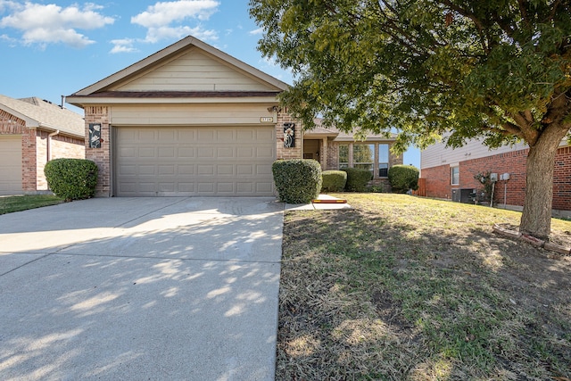 ranch-style house featuring a garage and a front yard