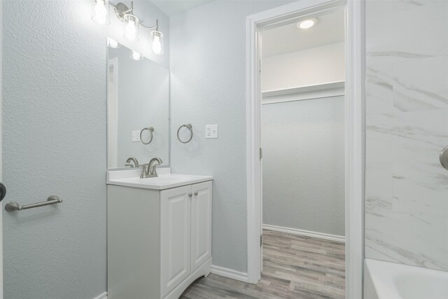 unfurnished room with light wood-type flooring, a wealth of natural light, and ceiling fan