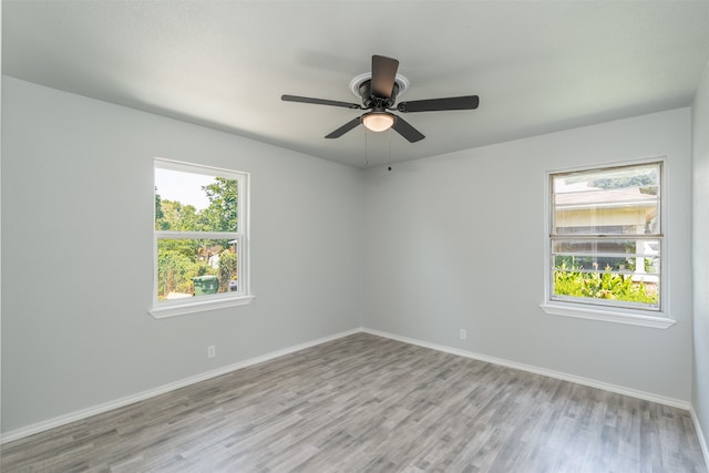 unfurnished room featuring light hardwood / wood-style flooring, ceiling fan, and plenty of natural light