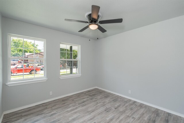 unfurnished room with light hardwood / wood-style floors and a healthy amount of sunlight