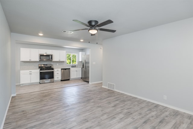 kitchen with stainless steel appliances, light hardwood / wood-style floors, ceiling fan, and white cabinetry