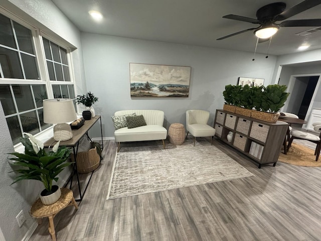 sitting room featuring baseboards, ceiling fan, visible vents, and wood finished floors