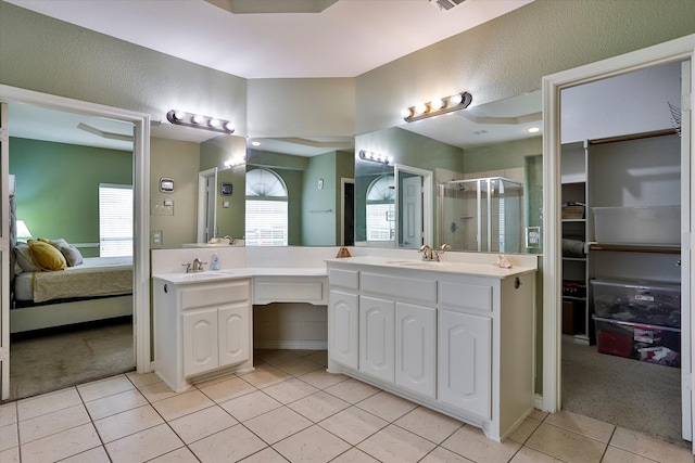 bathroom featuring vanity, tile patterned flooring, and plenty of natural light