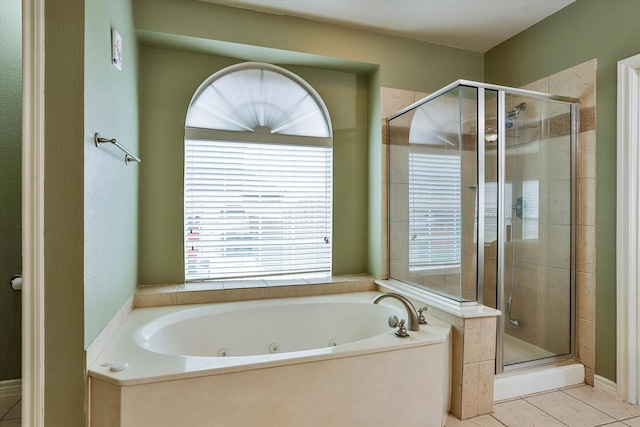 bathroom featuring tile patterned flooring and shower with separate bathtub