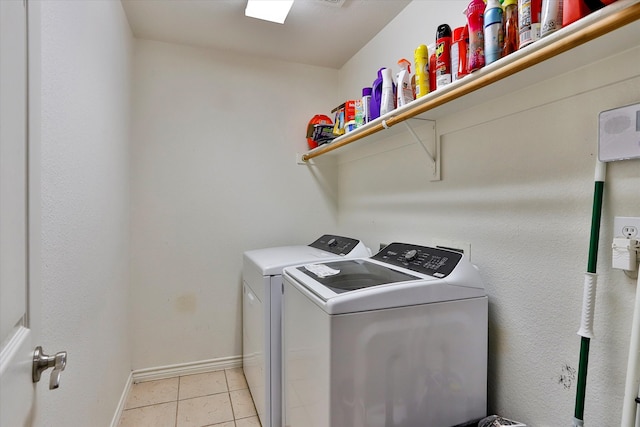 washroom featuring light tile patterned floors and washer and dryer