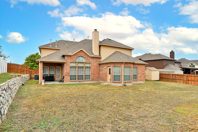 back of property with a lawn and a patio area