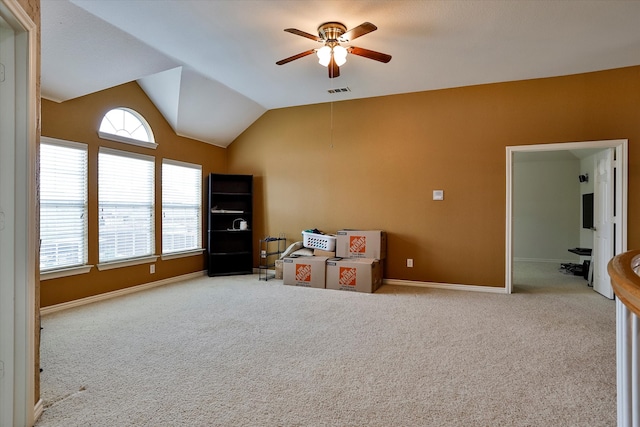 interior space featuring light carpet, ceiling fan, and vaulted ceiling