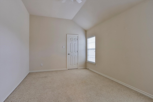 empty room featuring light colored carpet and lofted ceiling