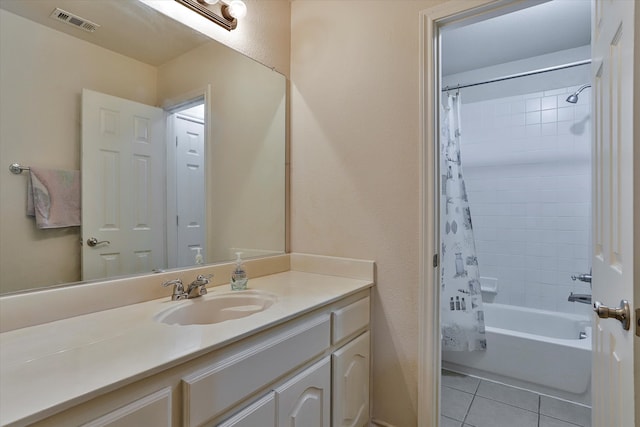 bathroom featuring vanity, shower / bath combo with shower curtain, and tile patterned floors