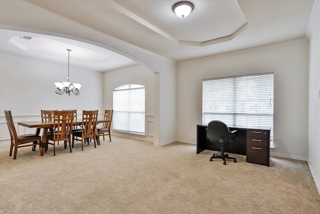 carpeted home office featuring ornamental molding, a wealth of natural light, a chandelier, and a raised ceiling