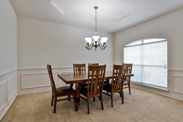 carpeted dining space with a notable chandelier