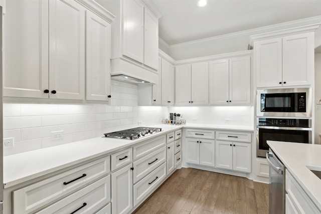 kitchen featuring stainless steel appliances, light hardwood / wood-style floors, and white cabinets