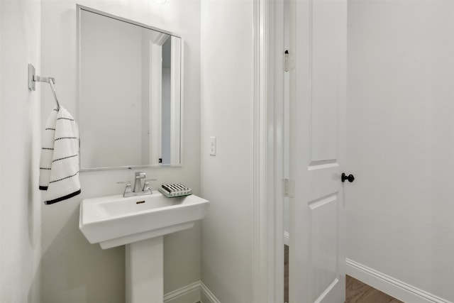 bathroom with hardwood / wood-style flooring