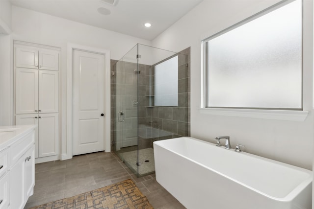 bathroom featuring vanity and separate shower and tub