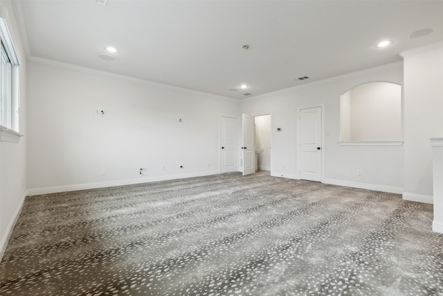 carpeted spare room featuring crown molding