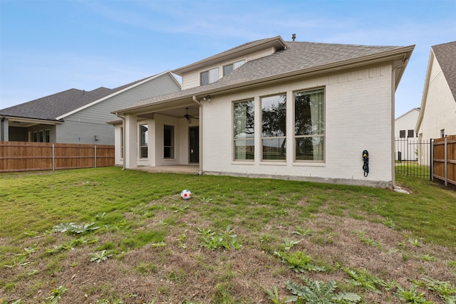 rear view of house featuring a lawn