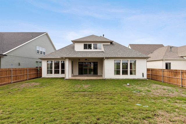 back of house featuring a lawn and a patio area