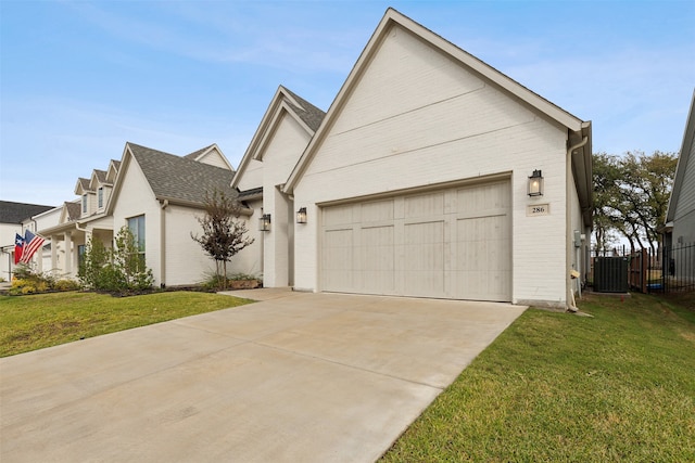 view of front of house featuring central air condition unit, a garage, and a front lawn