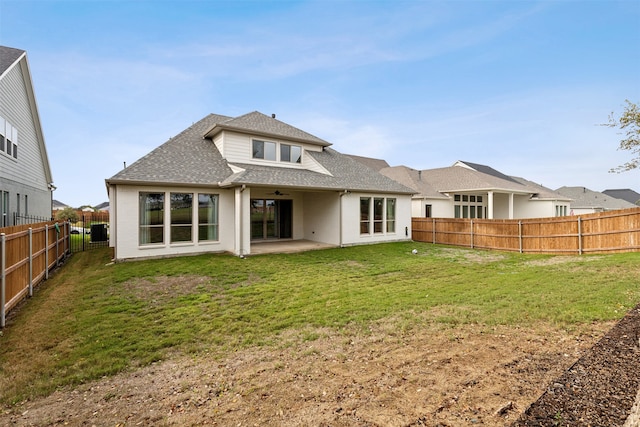 rear view of property featuring a yard and a patio area