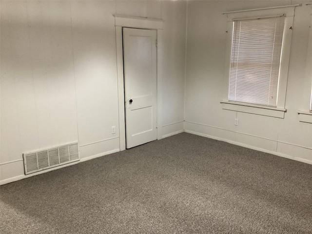 604 S Seaman St, Eastland, TX 76448 - unfurnished room with dark colored carpet and baseboards