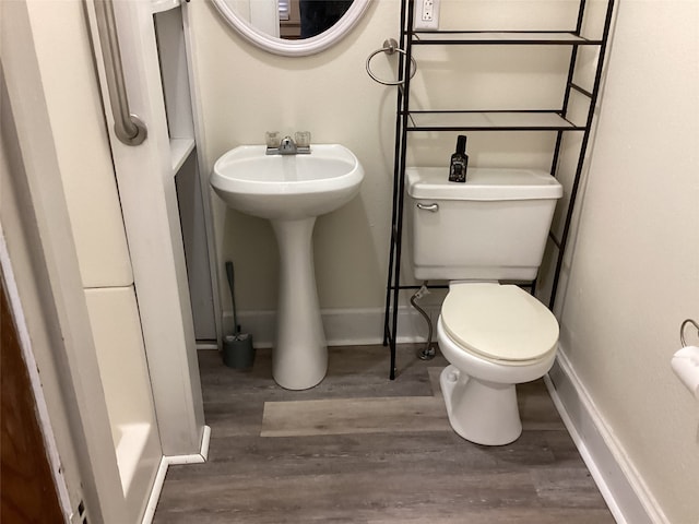 bathroom featuring hardwood / wood-style flooring, toilet, and sink