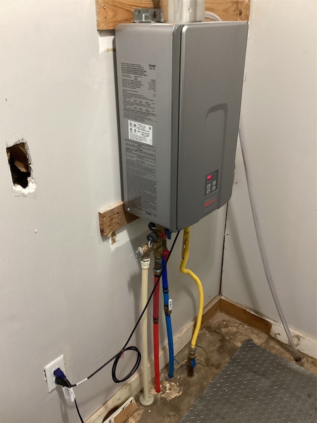 utility room featuring tankless water heater