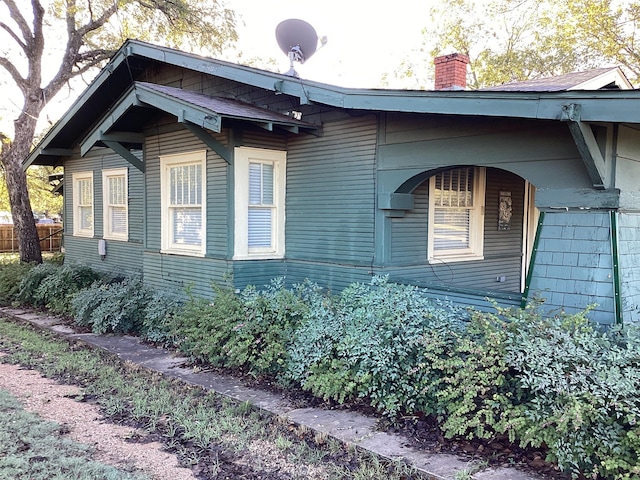 604 S Seaman St, Eastland, TX 76448 - view of side of home with a chimney
