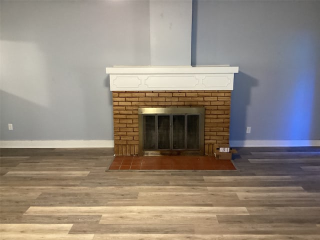 interior details with wood-type flooring and a fireplace