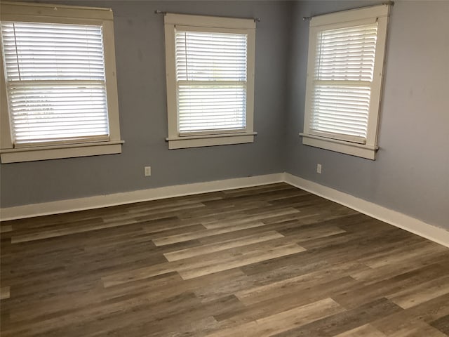 empty room featuring dark wood-type flooring