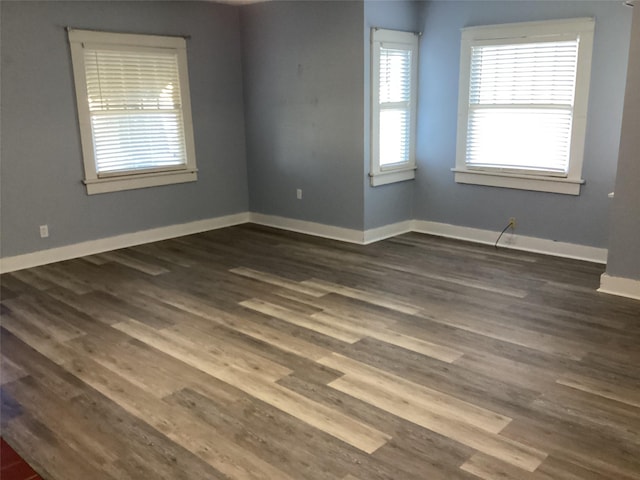604 S Seaman St, Eastland, TX 76448 - empty room featuring baseboards and dark wood finished floors