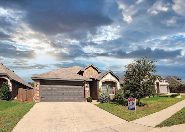 view of front of property featuring a garage and a front lawn