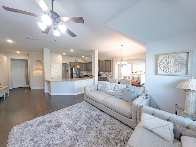 living room featuring vaulted ceiling, ceiling fan, and dark wood-type flooring