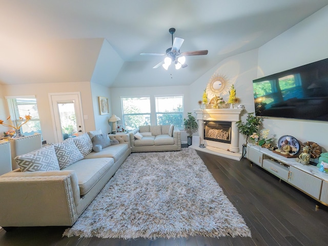 living room featuring ceiling fan with notable chandelier and dark hardwood / wood-style flooring