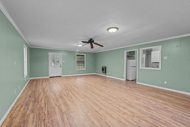 unfurnished living room with light hardwood / wood-style floors, ceiling fan, crown molding, and heating unit