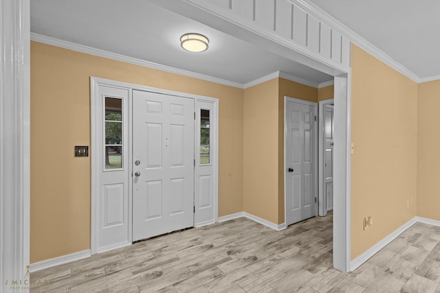 foyer featuring ornamental molding and light hardwood / wood-style flooring